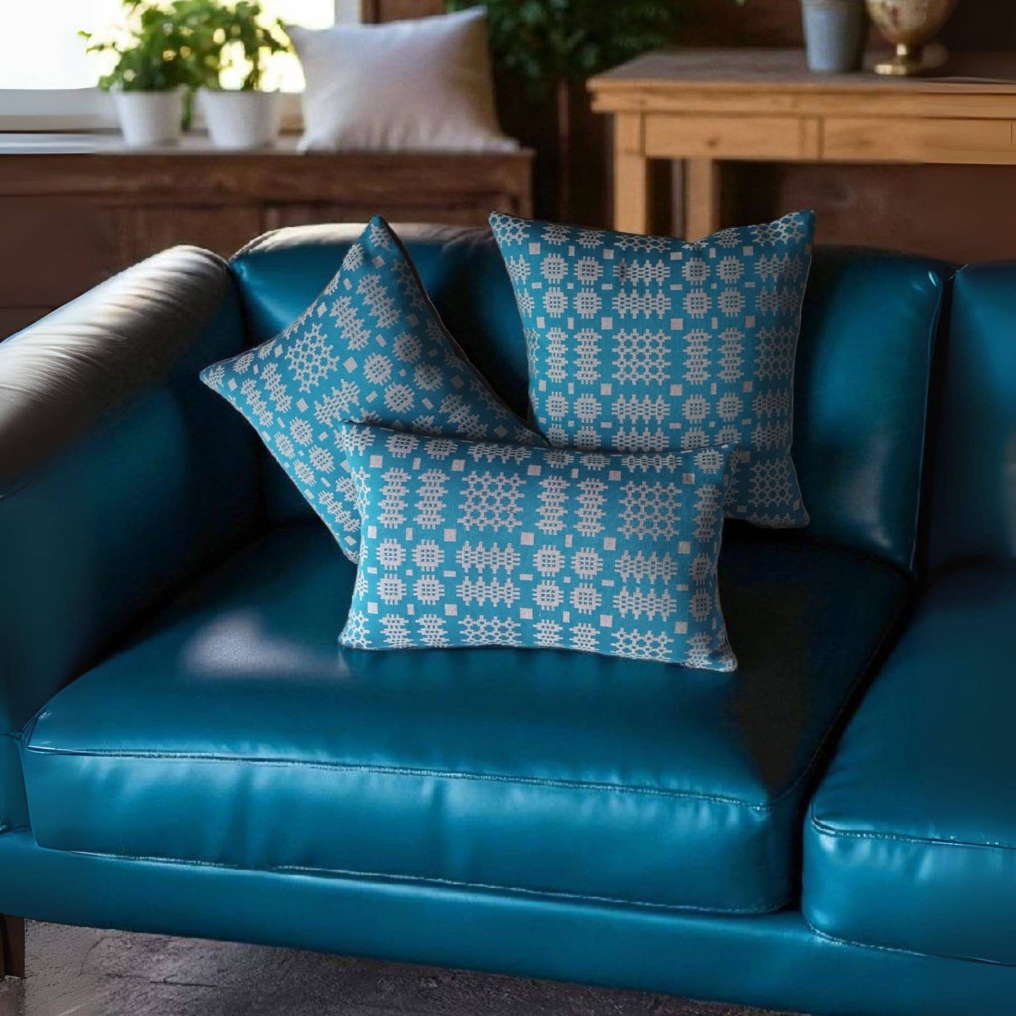 Teal Welsh tapestry design cushion with charcoal reverse