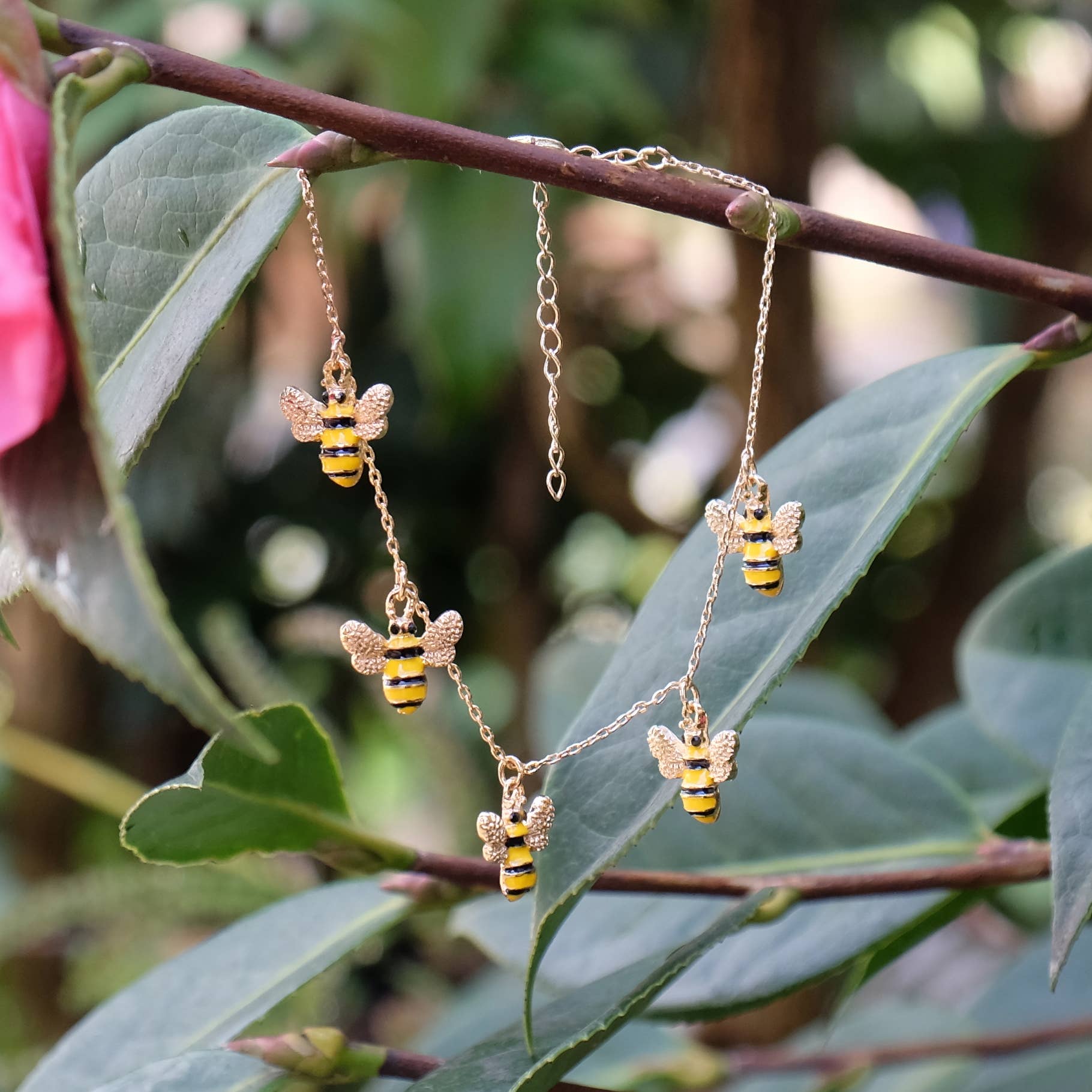 Gold-plated charm bracelet with five enamel bumble bees